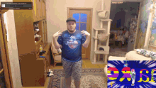 a man wearing a blue shirt that says just dance