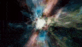 a painting of a colorful explosion in the middle of a dark space