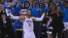 a basketball player with the number 12 on his jersey is celebrating