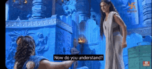 a man and a woman are standing next to each other and the woman is asking the man how he understands .