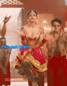 a woman in a red and gold dress is dancing with a caption that says thiruda chato