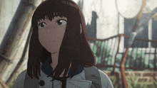a close up of a girl 's face with brown hair