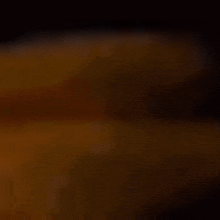 a blurred image of a person 's face in the dark .