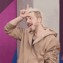 a man wearing glasses is sticking his tongue out and making a funny face