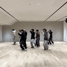 a group of people are dancing in a room