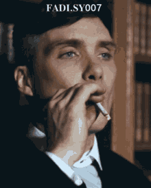 a man in a suit smoking a cigarette with fadi sy007 written on the bottom
