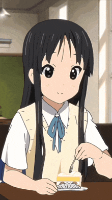 a girl is sitting at a table with a piece of cake in front of her