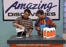 two men are pouring milk into a glass in front of a sign that says amazing discovery .