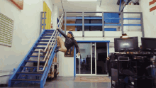a man in a patagonia jacket climbs a set of stairs
