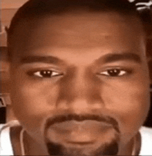 a close up of a man 's face with a beard and headphones on .