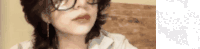 a woman wearing glasses and earrings is talking to someone .