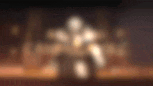 a blurry picture of a person standing in front of a fire with a dark background .