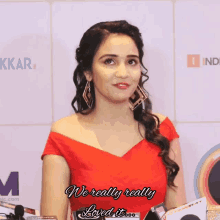 a woman in a red dress with the words we really really loved it behind her