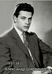 a black and white photo of a man in a suit