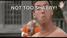 a shirtless man is standing in front of a clown and says `` not too shabby '' .
