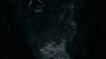a silhouette of a person riding a bike in front of a full moon at night .