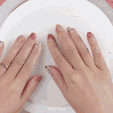 a close up of a person 's hands with easy plus written on the bottom right