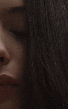 a close up of a woman 's face with her eyes closed