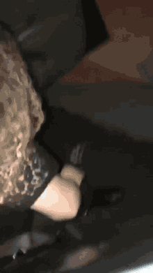 a woman in a black dress is sitting on a couch