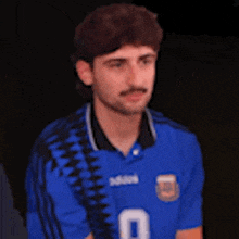 a man is wearing a blue jersey with the number 0 on it