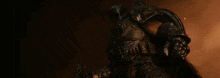 a person in a dark room with a shield on their head
