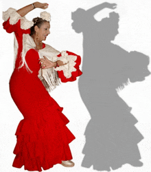 a woman in a red dress with white ruffles is dancing