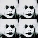 a black and white photo of a woman with makeup on