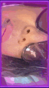 a picture of a woman 's face with a purple frame
