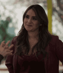 a woman wearing a red jacket and a silver necklace