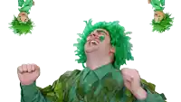 a man wearing a green wig and leaves on his body
