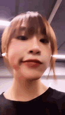 a close up of a woman 's face with a blurred background .