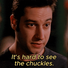 a close up of a man 's face with the words it 's hard to see the chuckles below him