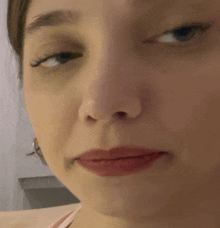 a close up of a woman 's face with red lips