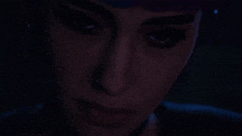 a close up of a woman 's face with blue eyes
