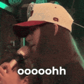 a woman wearing a hat is singing into a microphone and the word dito is on the bottom right