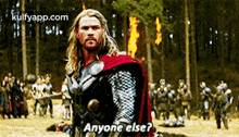 thor is standing in the middle of a field with a group of people in the background and asking anyone else .