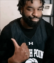 a man with a beard wearing a jersey that says h point