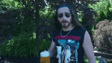 a man with long hair and a beard is drinking from a bottle
