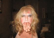 a woman with lipstick on her face holds her hands together