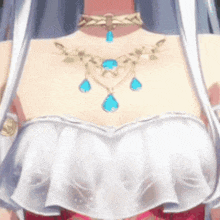 a close up of a woman wearing a necklace with blue stones