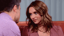 a man and woman are looking at each other