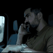 a man with a beard is talking on a cell phone with the words locasporponcho below him