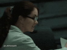 a woman wearing glasses and a lab coat has the username lialmeida05 on the bottom right