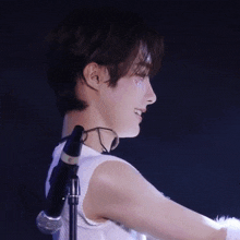 a person with a choker around their neck stands in front of a microphone that has the letter c on it