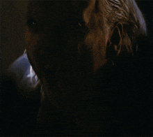 a close up of a vampire 's face with his mouth wide open