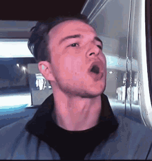 a man with his mouth open looks at the camera