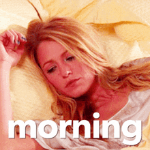 a woman laying on a bed with the word morning behind her