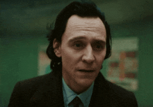 a close up of a man in a suit and tie making a funny face .
