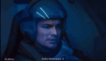a man wearing a helmet and headphones looks up at the sky