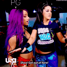 two women are standing next to each other and one has a shirt that says boss hug connection